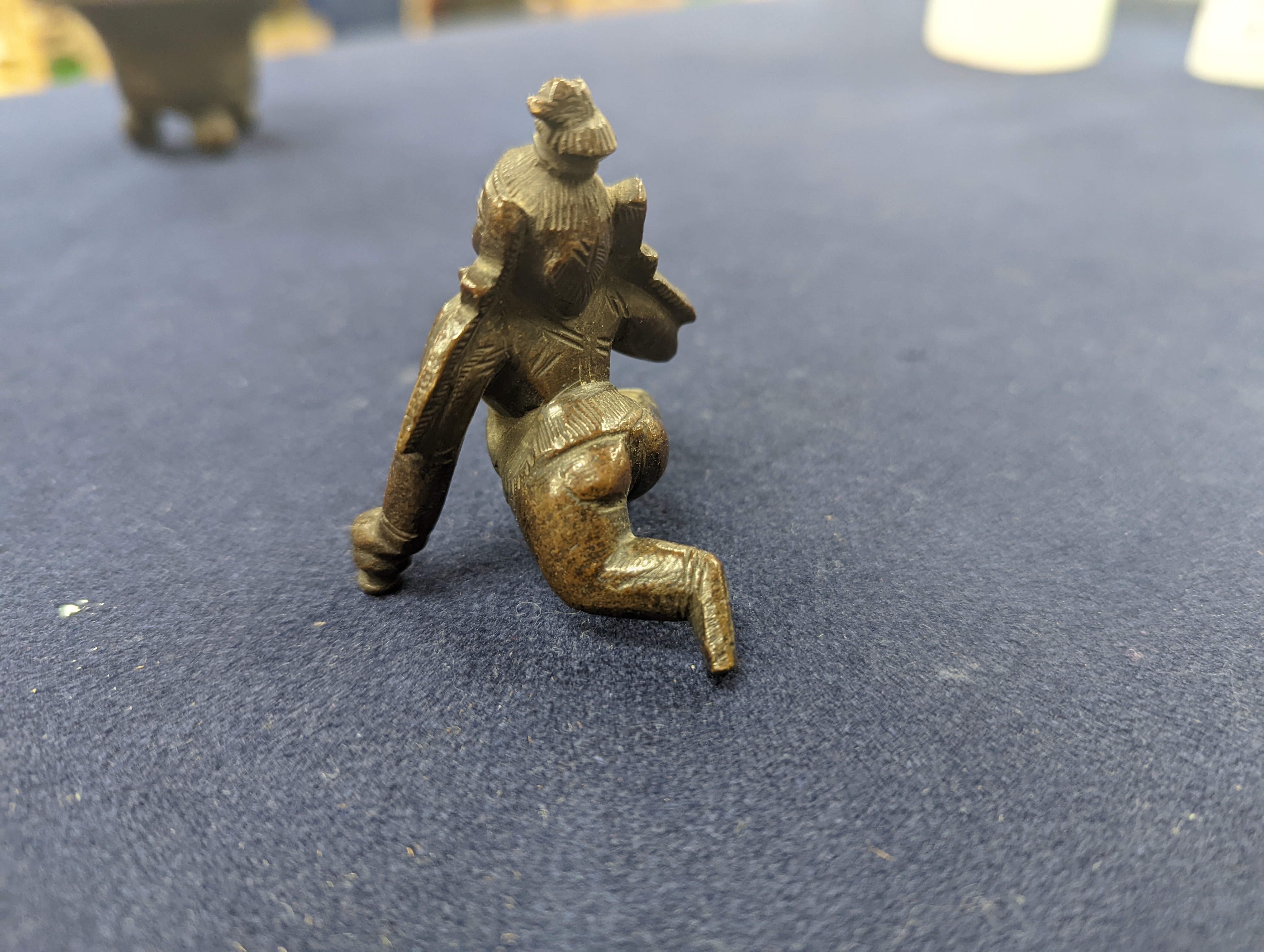 A Chinese gilt copper figure, a Chinese Dog of Fo, a bell, a censer, six Indian bronze figures and a scroll box